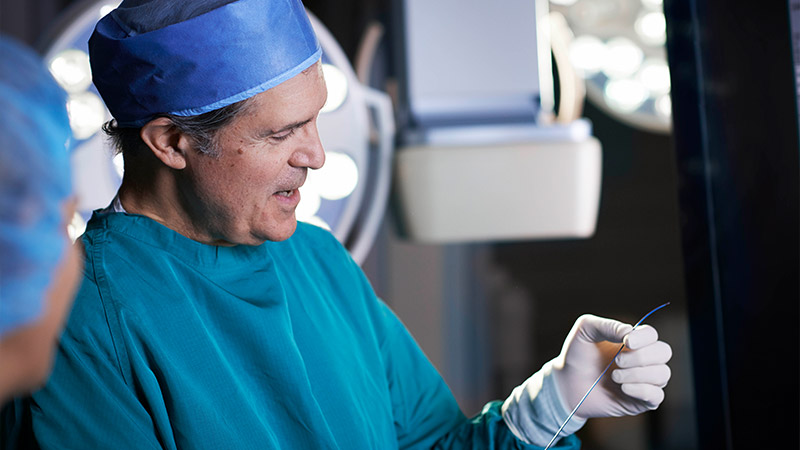 Image of surgeon holding a tool
